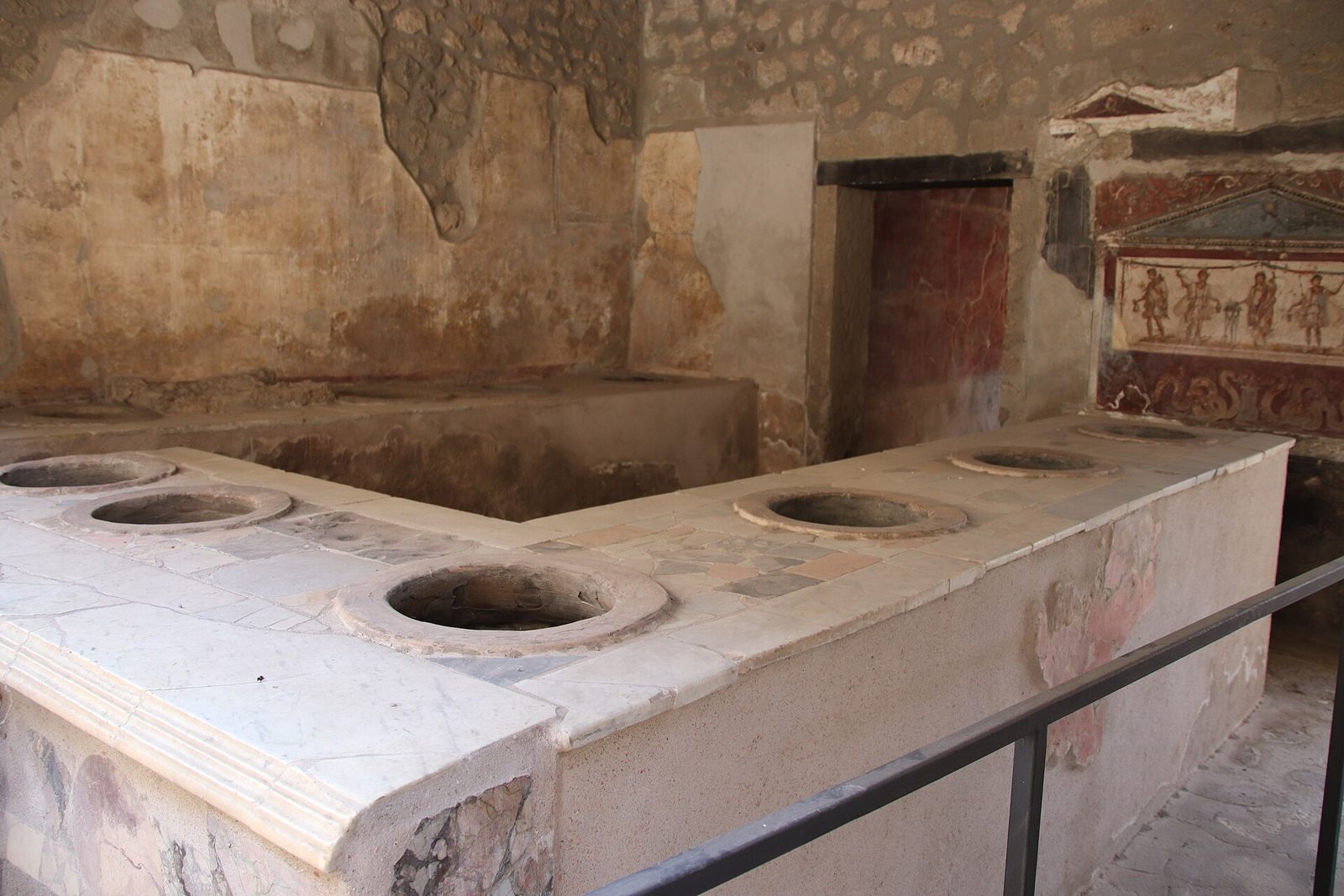 The marble counter of the Thermopolium of Vetutius Placidus in Pompeii, with its painted household shrine