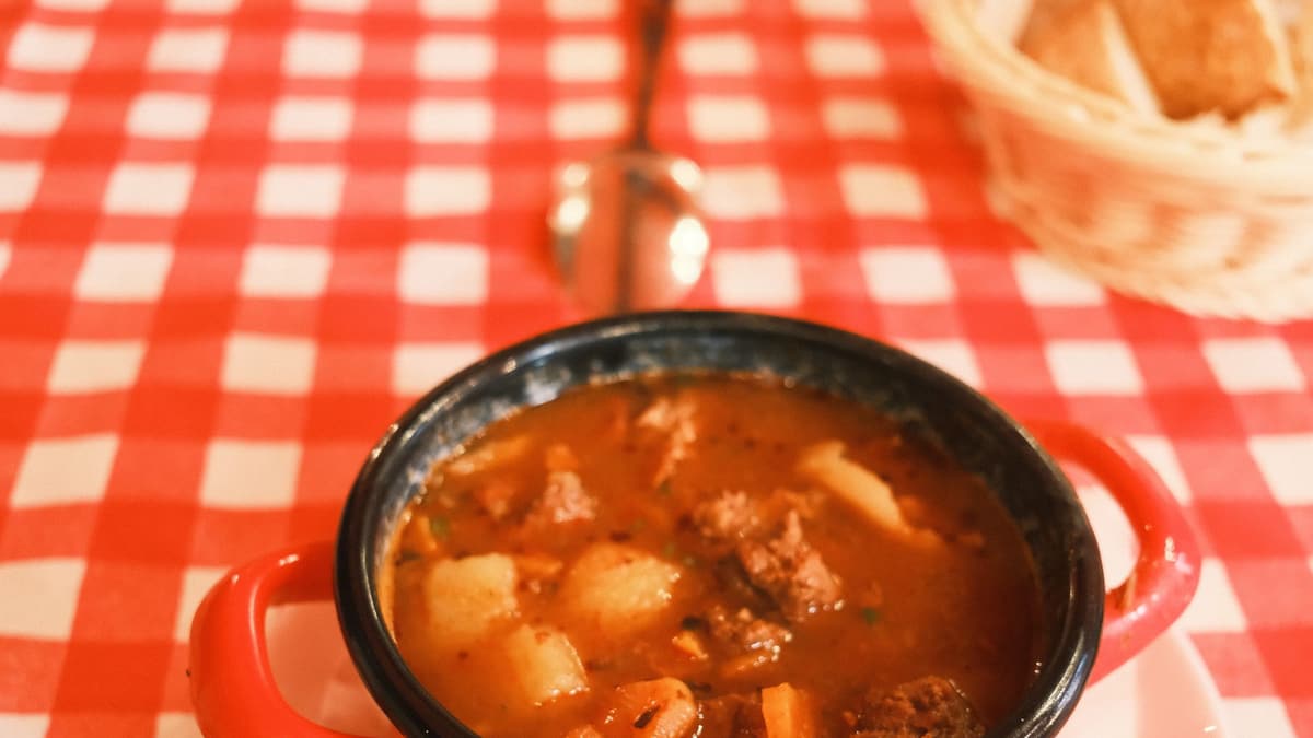 Hungarian goulash soup in a red pot in Budapest