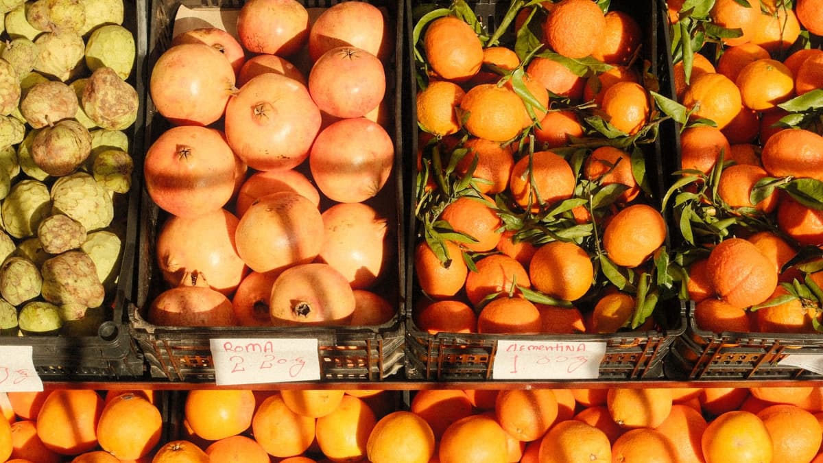 Crates of pomegranates and oranges at a Lisbon market