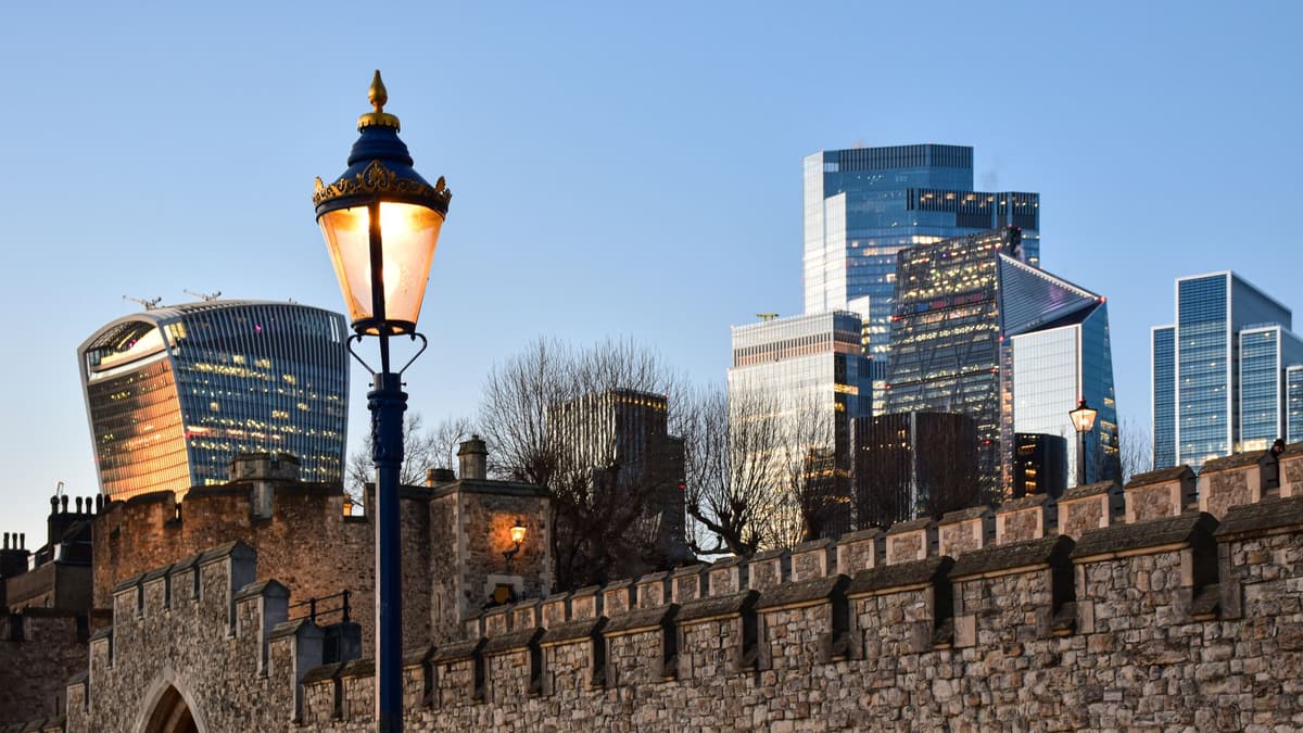 The Tower of London's walls and the City skyline, near Seething Lane
