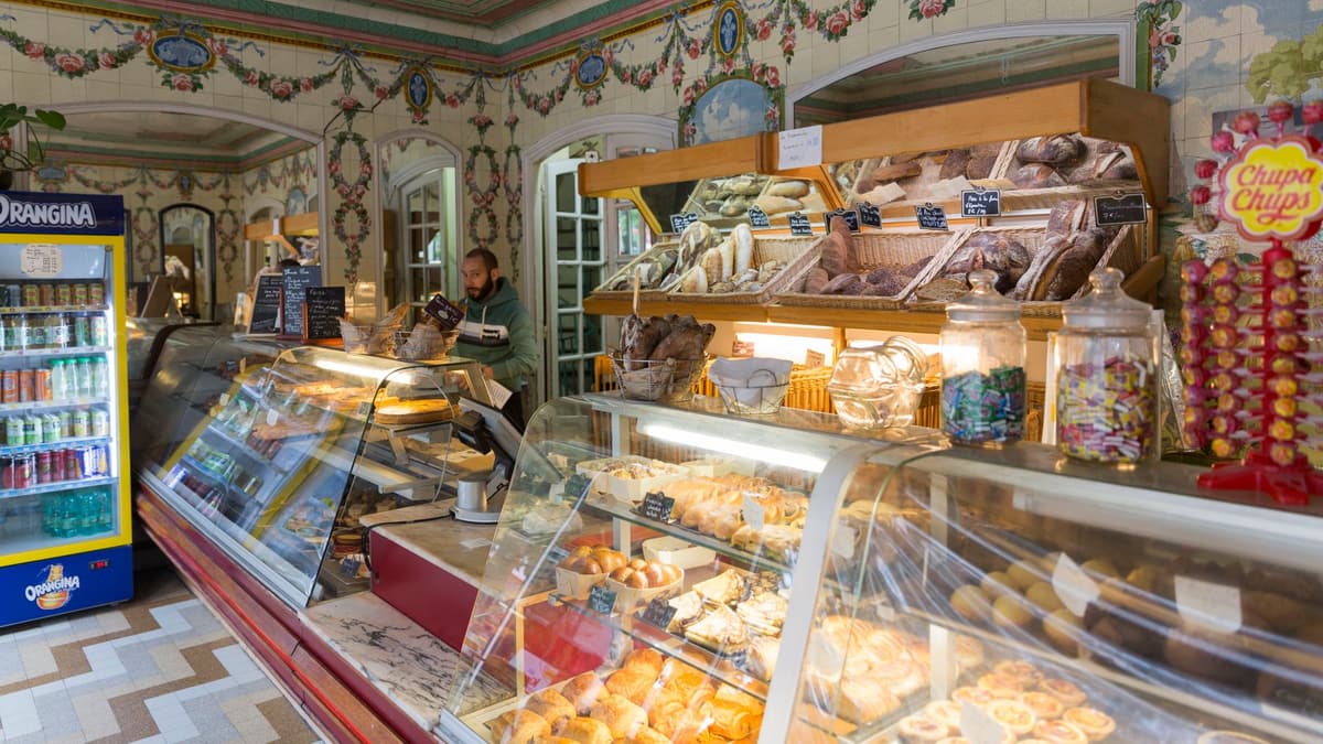 Old Paris bakery with a painted ceiling and pastry counters