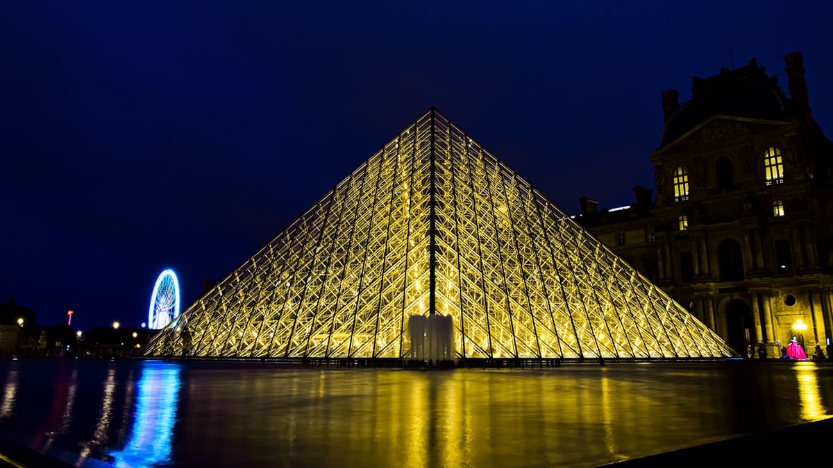 The Louvre Pyramid lit up at night, Paris