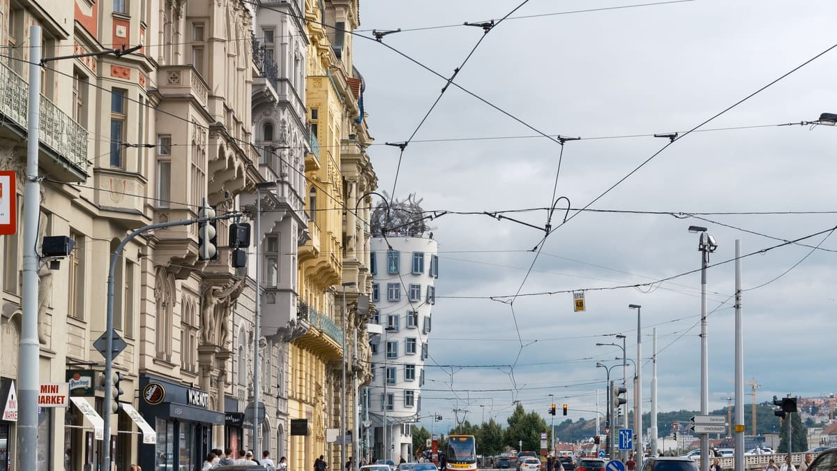 A tram street in Prague's New Town running down to the Dancing House by the Vltava