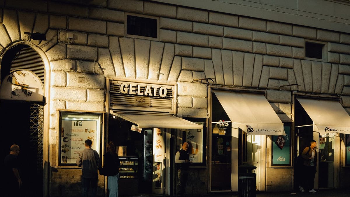 A gelato shop on a Rome street in the evening